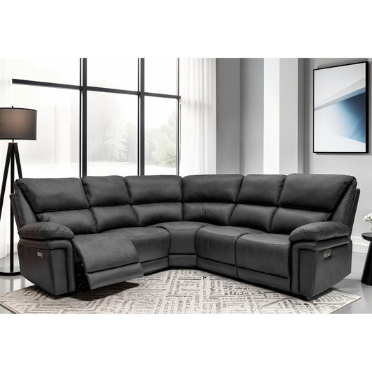 Grey sectional sofa in a living room setting with large windows and a lamp.