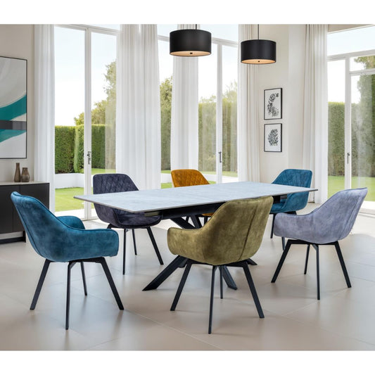 Modern dining room with a white table and colorful chairs in a bright room with large windows.