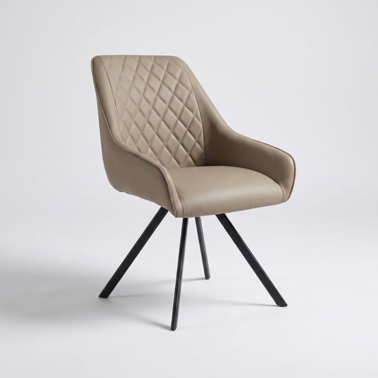 A modern swivel dining chair upholstered in taupe faux leather with a diamond-quilted backrest and curved armrests, supported by four black metal legs.