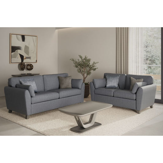 Blue sofa set in a living room with a coffee table and decorative items.