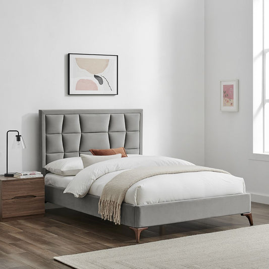 Gray upholstered bed with white bedding in a bedroom setting.