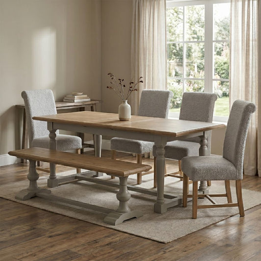 Dining room with wooden table, chairs, and bench in a well-lit room.