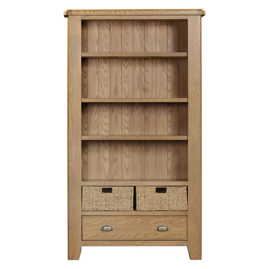 Wooden bookshelf with wicker baskets and drawers on a white background