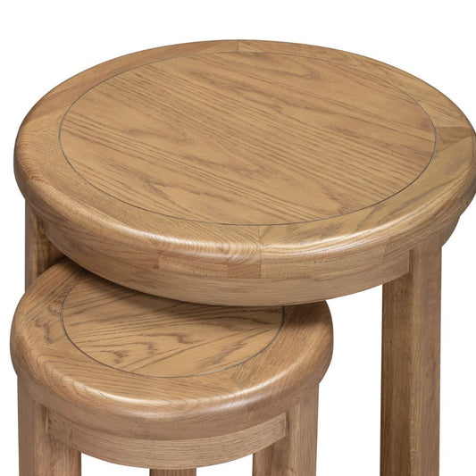 Two wooden nests with a round top and cylindrical base on a white background