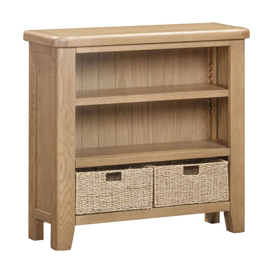 Wooden bookshelf with two woven baskets on a white background