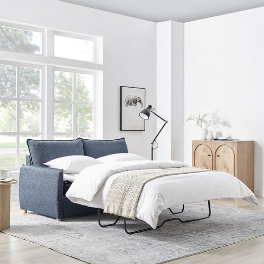 Sofa bed in a modern living room with a lamp and cabinet.