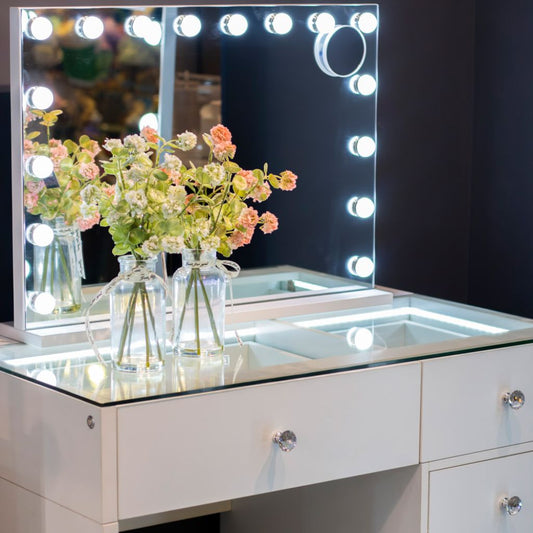 Makeup vanity with a mirror with lights.