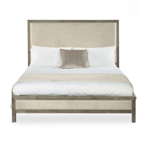A modern bed with a tall upholstered headboard and matching upholstered footboard.