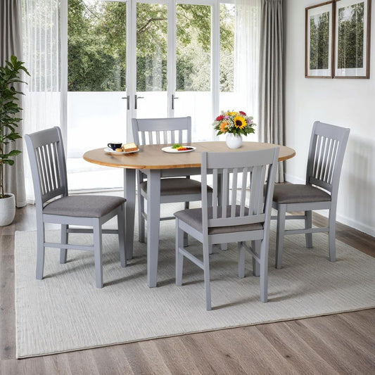 Dining room with a extending oval wooden table and four grey chairs
