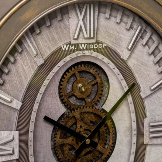 Close-up of a Wm. Widdop clock face with intricate gears and Roman numerals.