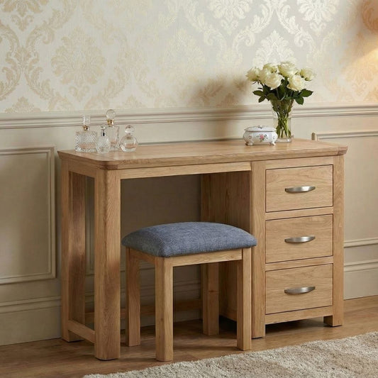 A stylish and modern oak dressing table set with 3 drawers and a matching stool.