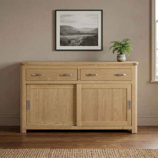 A solid oak sideboard cabinet with two drawers and two sleek sliding cabinet doors.