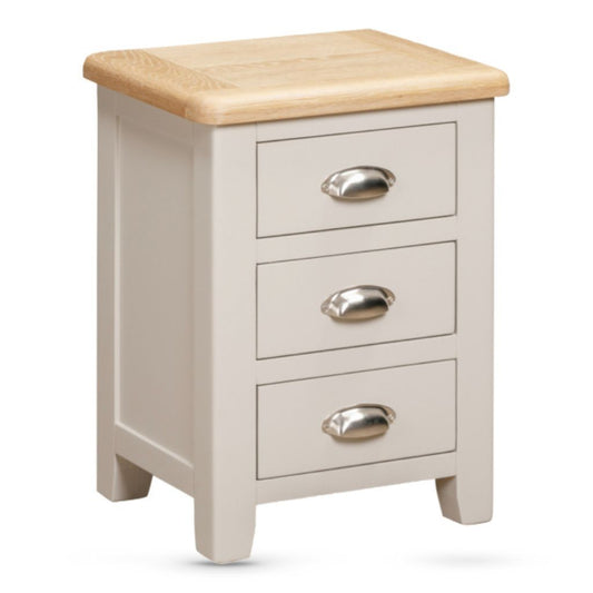 Small cabinet with three drawers and a wooden top on a white background