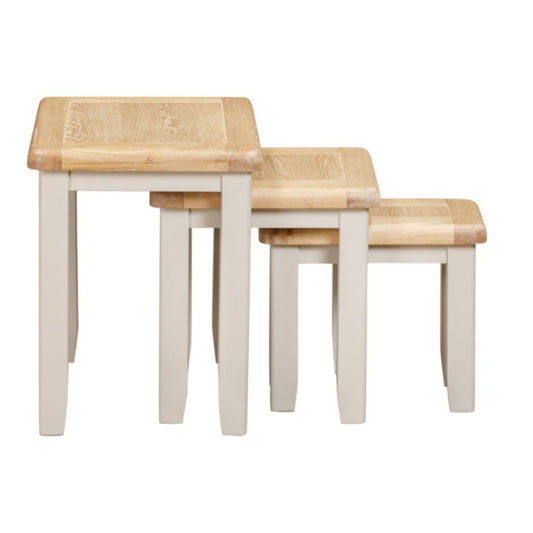Set of three wooden tables with a light finish on a white background