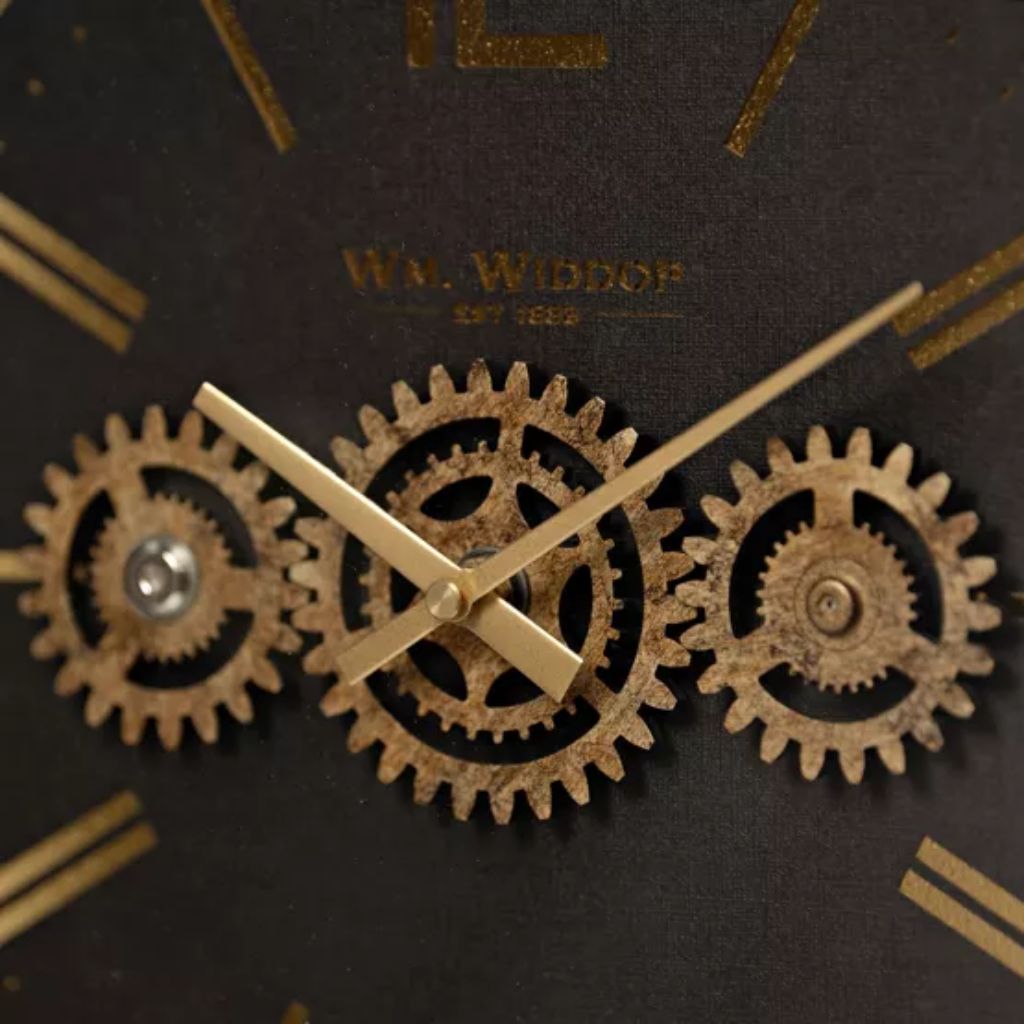 Close-up of a clock face with gears and 'W.M. Widdop' branding.