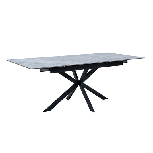 Modern dining table with marble top and black metal legs on a white background