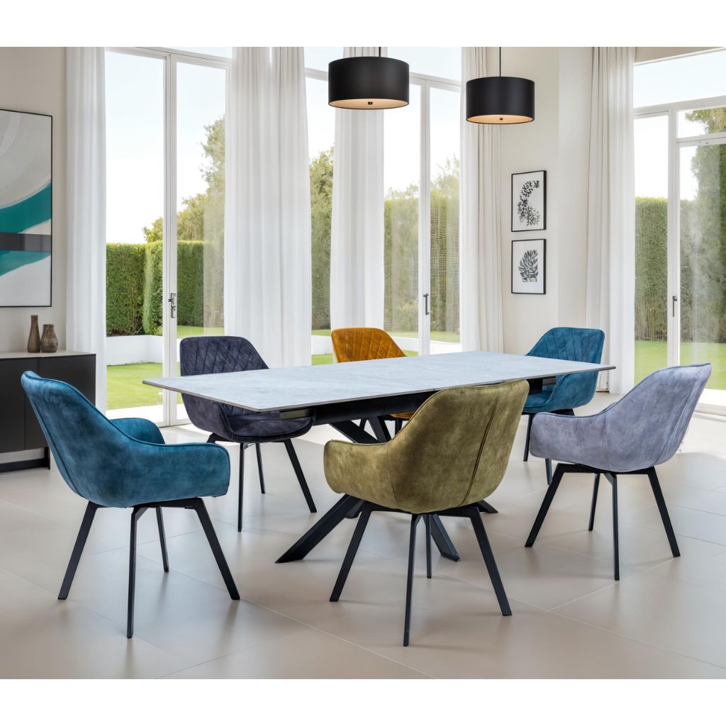 Modern dining room with a white table and colorful chairs in a bright room with large windows.