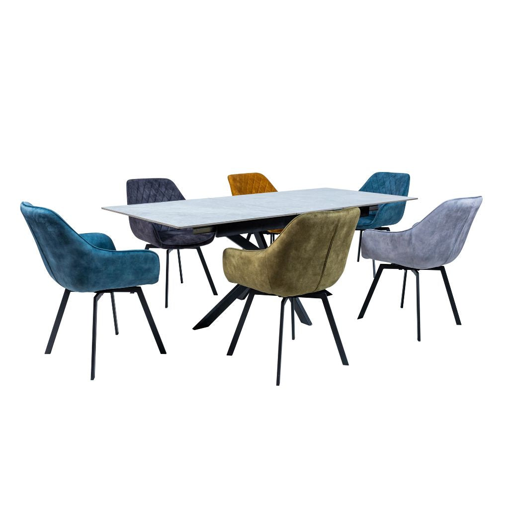 Dining table with six upholstered chairs in various colors on a white background