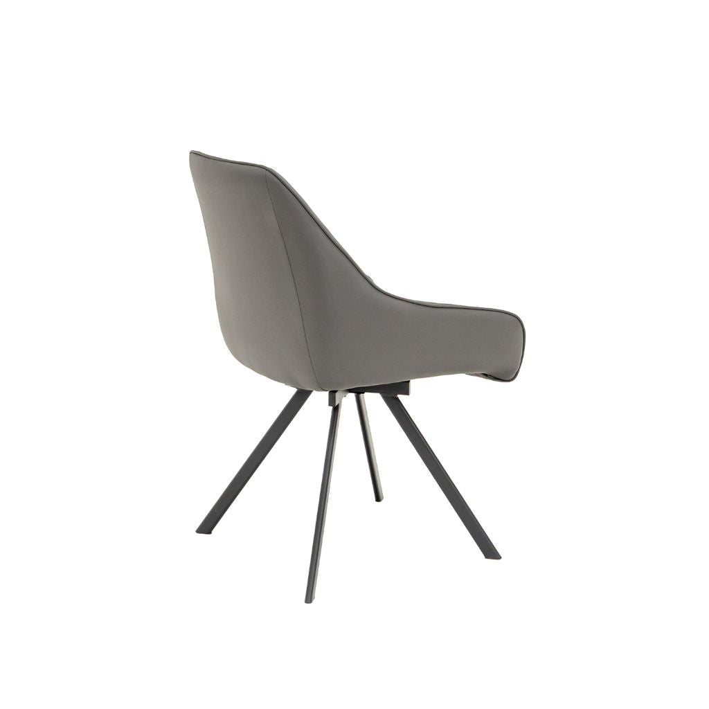 A modern grey upholstered dining chair with a curved backrest and swivel black metal legs.