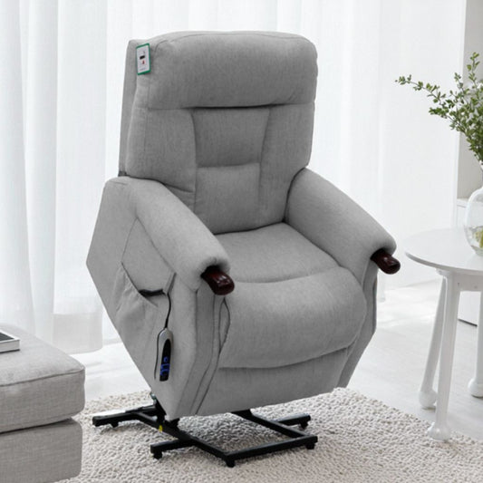 Gray recliner chair in a room with white curtains and a small table.