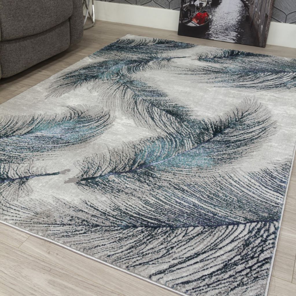 Abstract patterned rug on a wooden floor with a gray sofa in the background