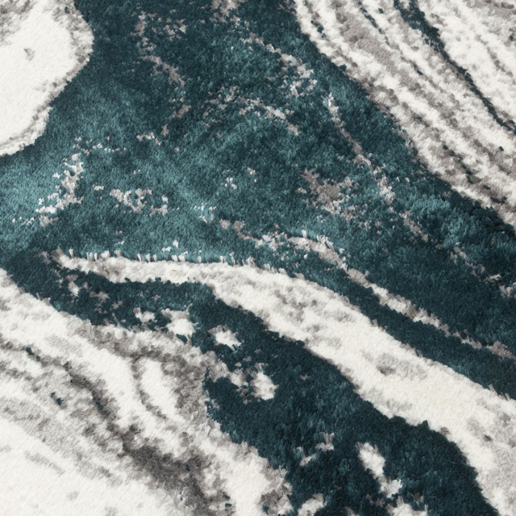 Close-up of a textured surface with wavy patterns in green and gray tones.