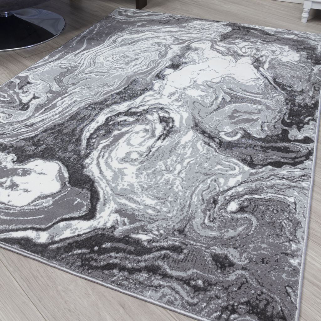 Gray and white marbled patterned rug on a wooden floor
