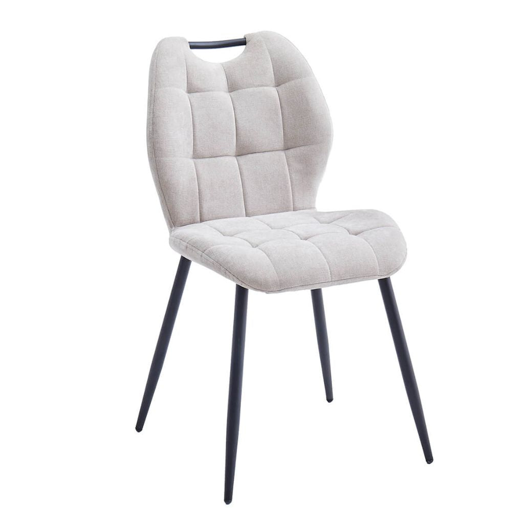 Beige upholstered chair with black legs on a white background