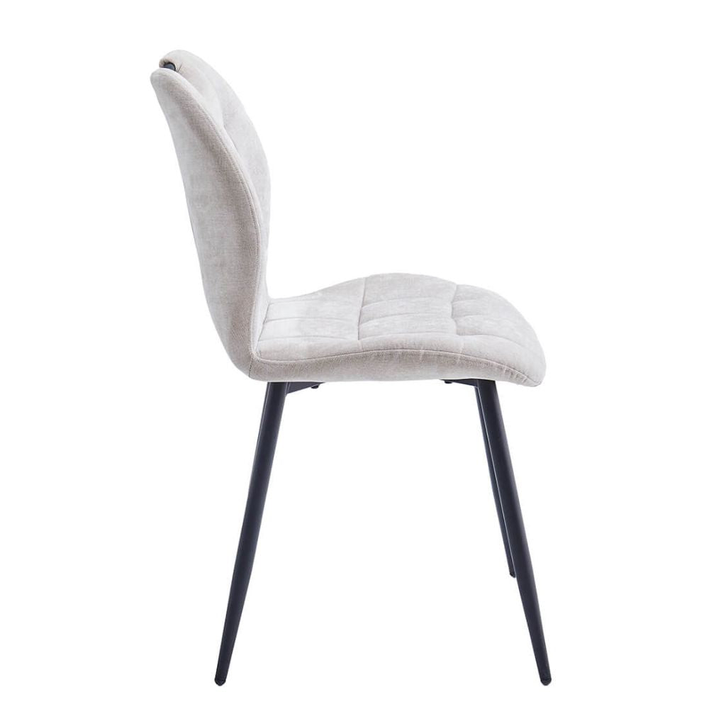 Beige upholstered chair with black legs on a white background