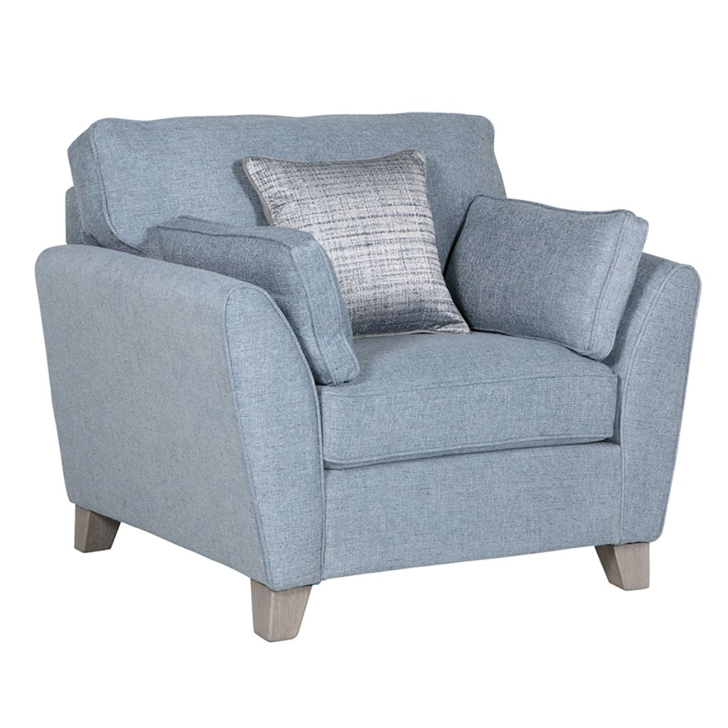 Blue armchair with cushions on a white background