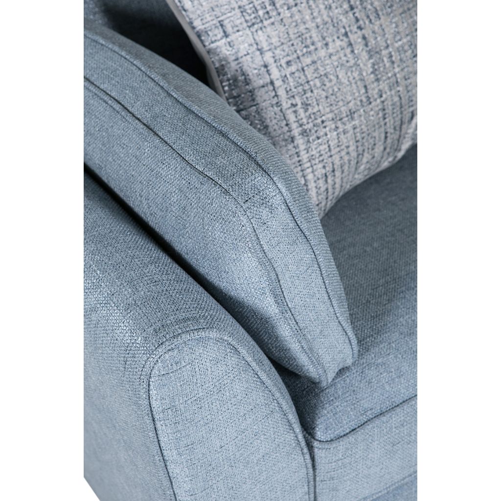 Close-up of a textured blue fabric chair with a white background