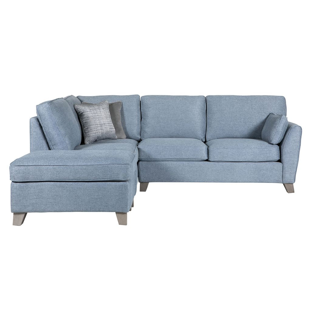 Blue sectional sofa with cushions on a white background