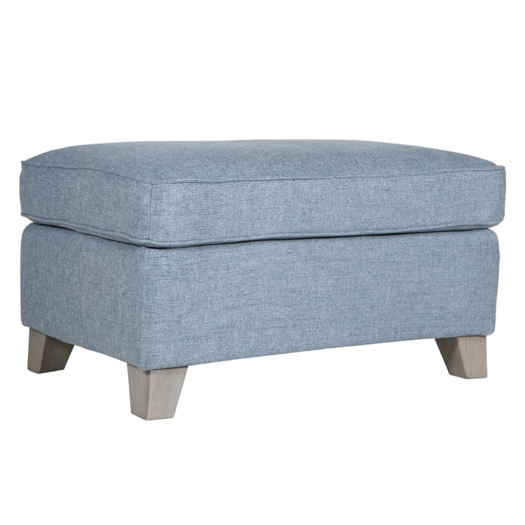 Blue upholstered ottoman on a white background