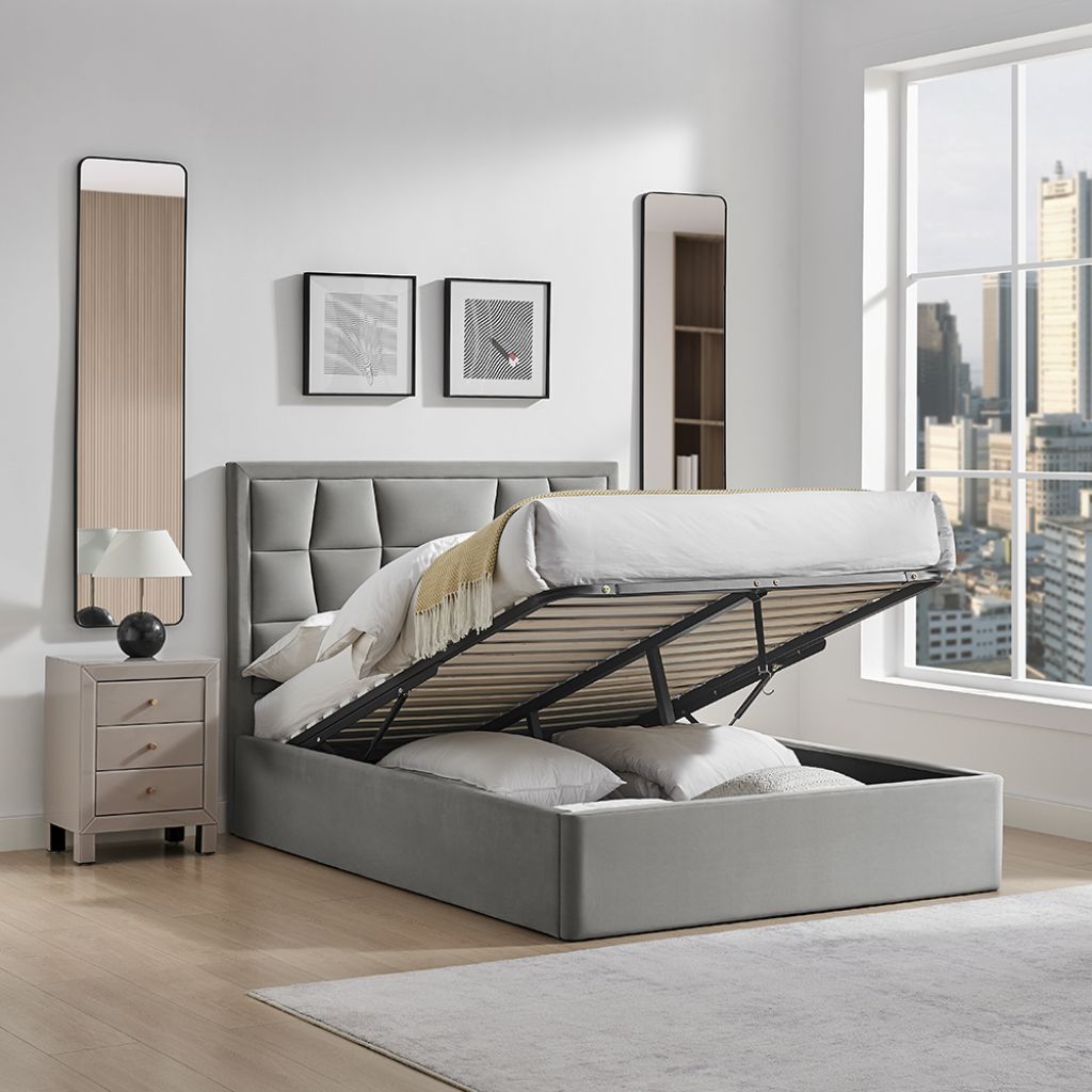 Gray upholstered bed with open storage drawers in a modern bedroom.