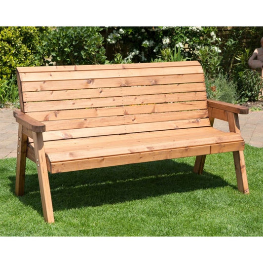 Wooden bench on grass with garden background