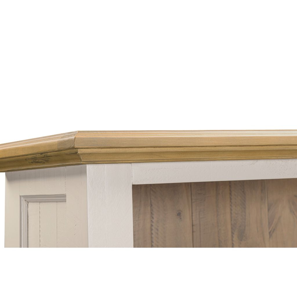 Wooden cornice on a white wall with wooden paneling