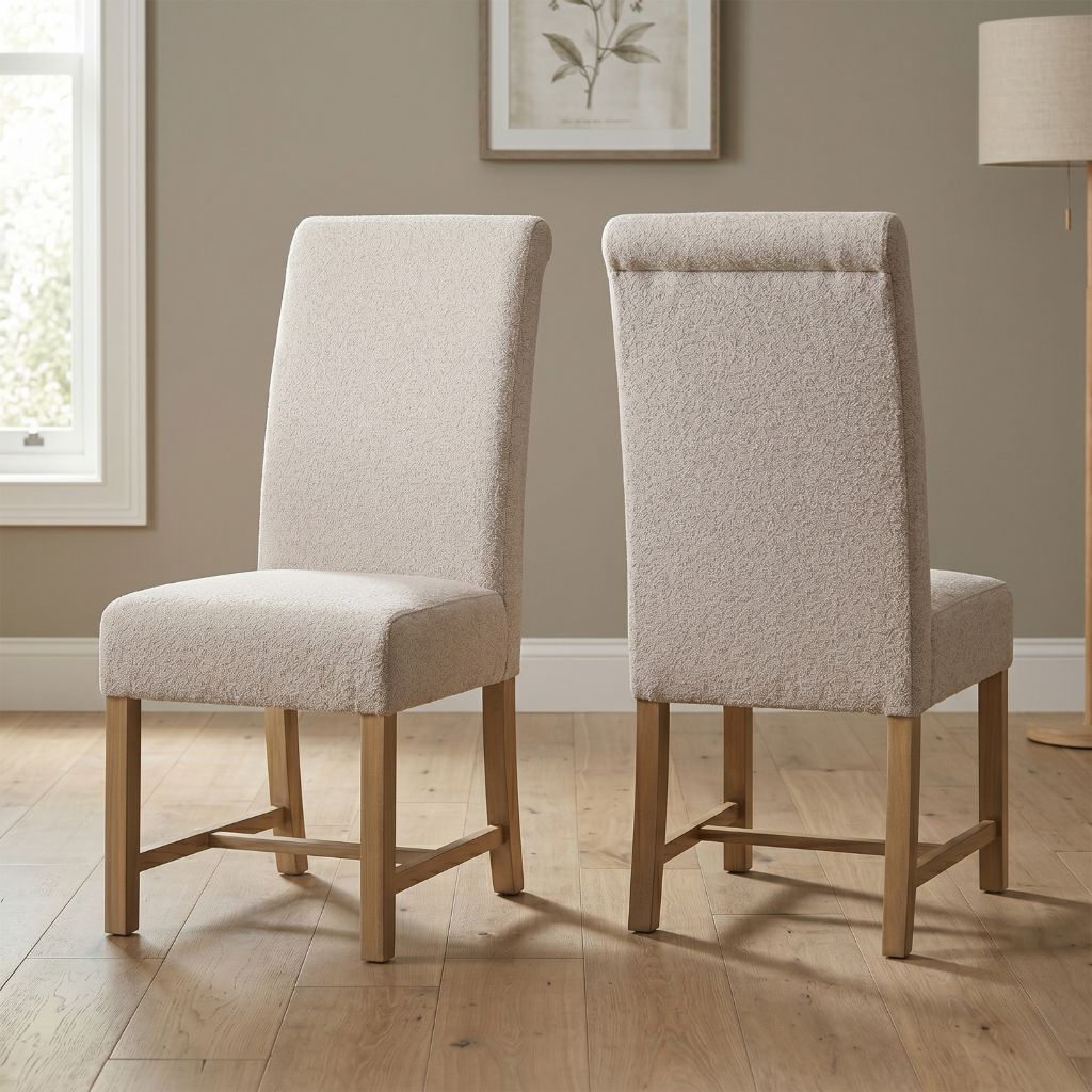 Two beige upholstered chairs with pine wood legs.