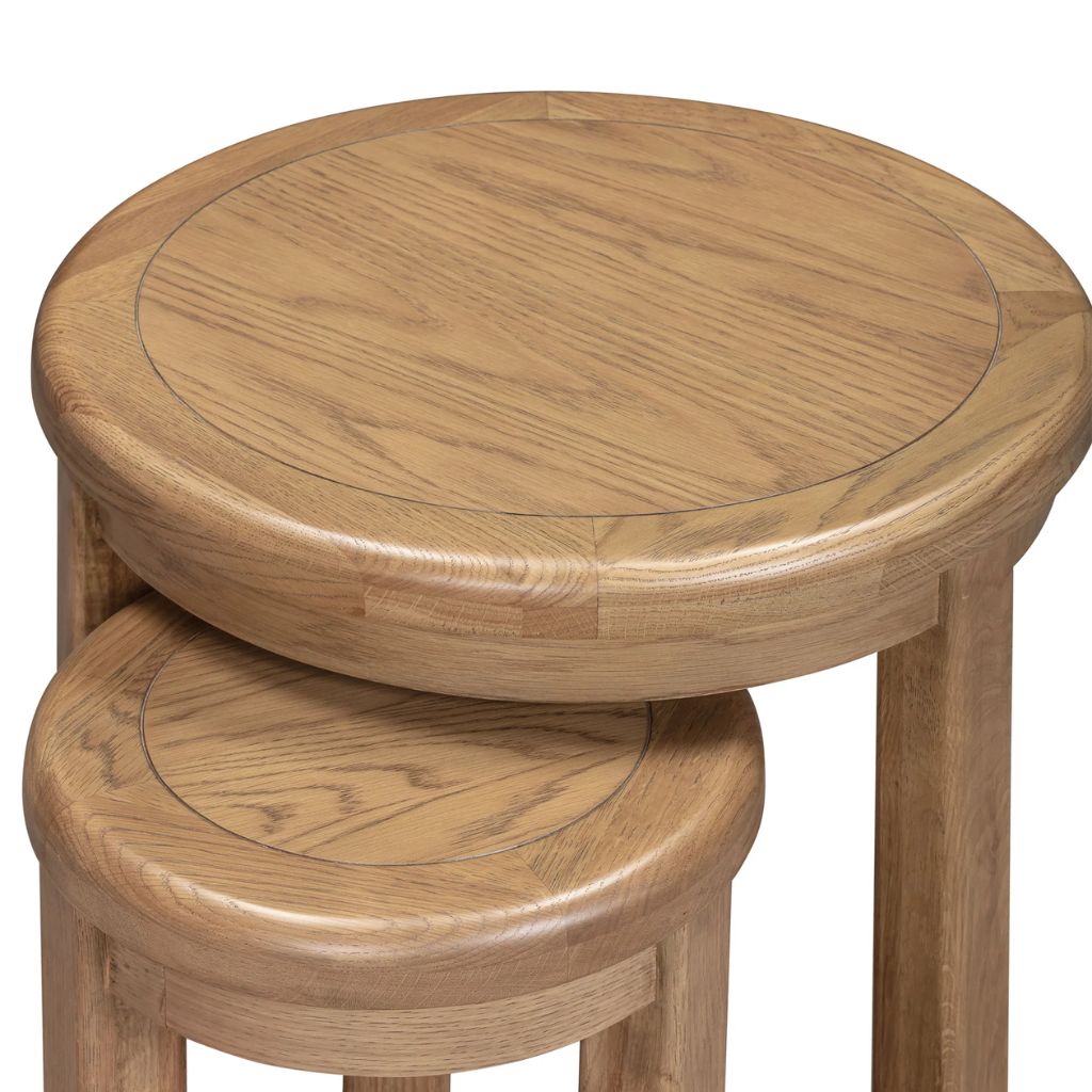 Two wooden nests with a round top and cylindrical base on a white background