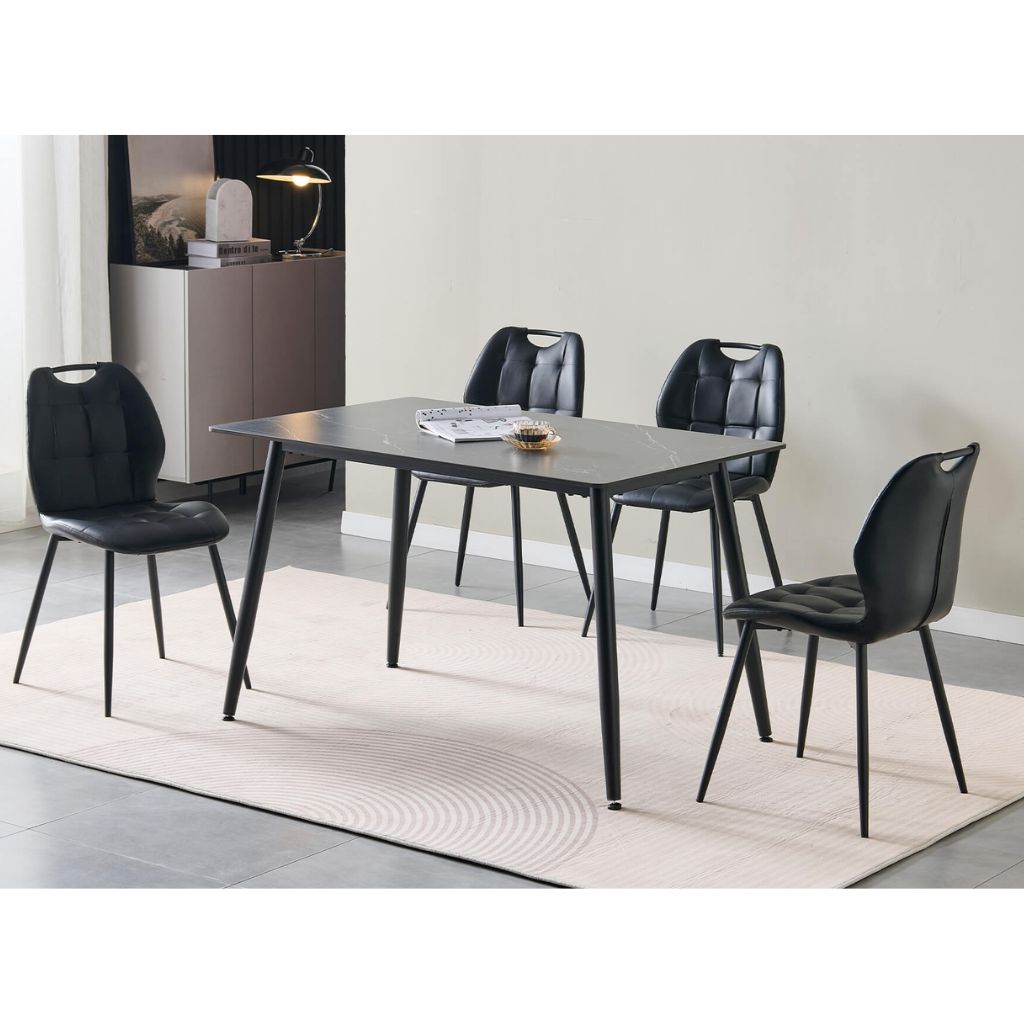 A 5-piece dining set featuring a rectangular black table and four matching black chairs with a unique cutout back design 