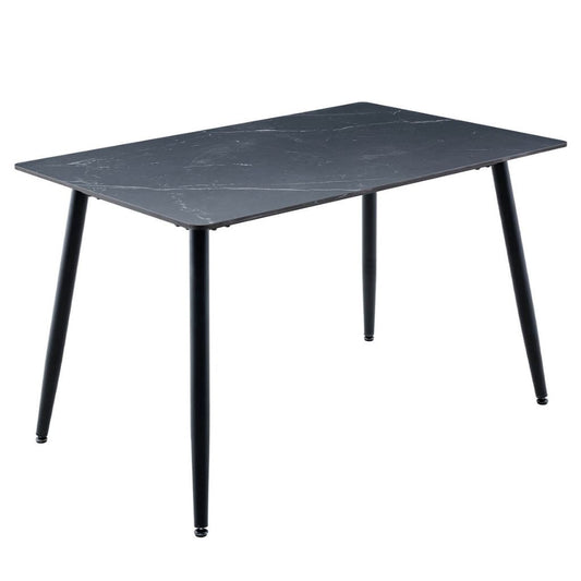 A rectangular black dining table with a black sintered stone top and four tapered black legs.