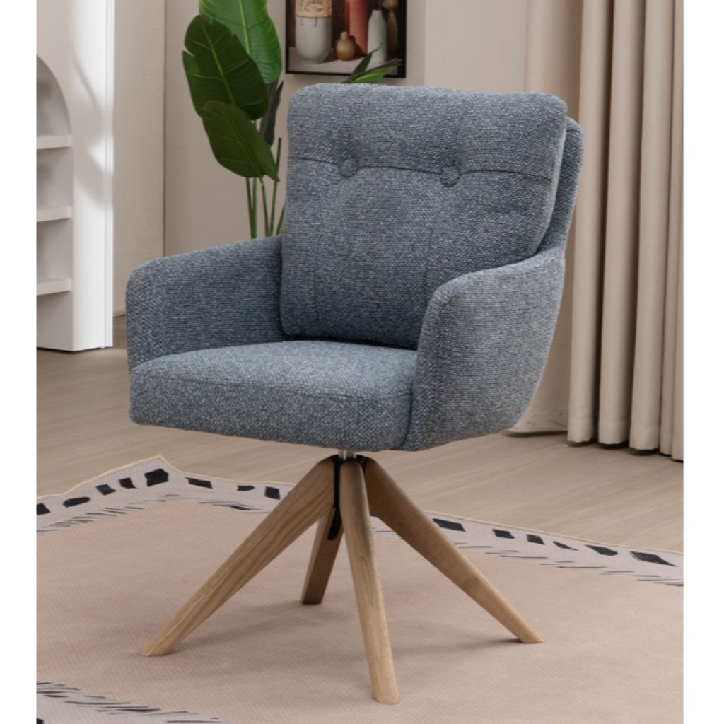 Blue upholstered chair with wooden legs in a room setting