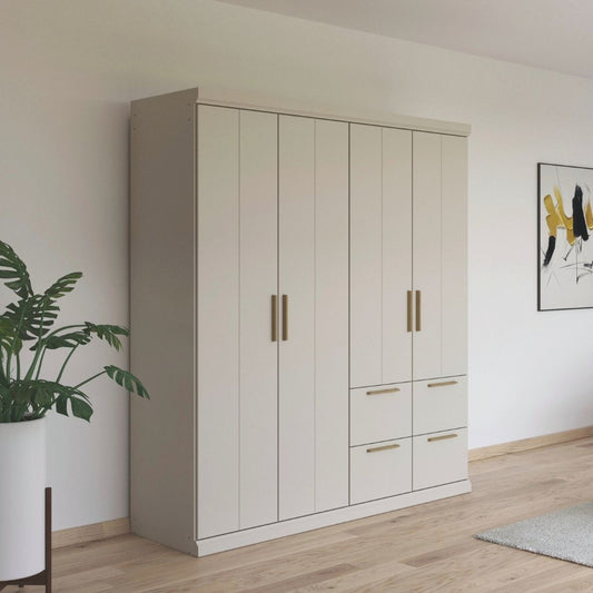Beige wardrobe with oak handles in a room with a plant and abstract art on the wall.