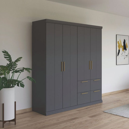 Gray wardrobe with oak handles in a room with a plant and artwork.