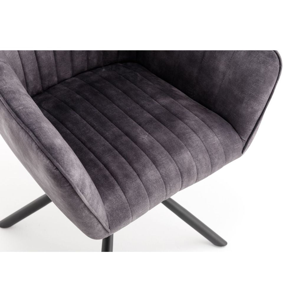 Grey velvet chair with black metal legs on a white background