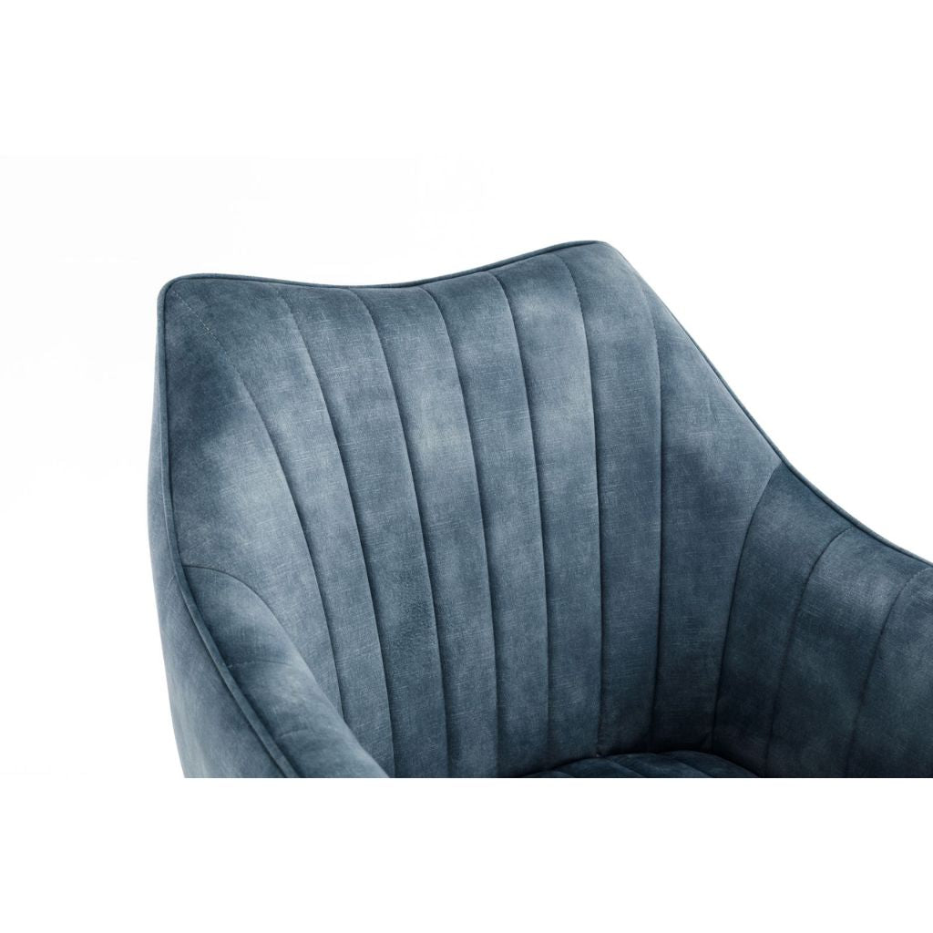 Close-up of a blue velvet chair armrest on a white background