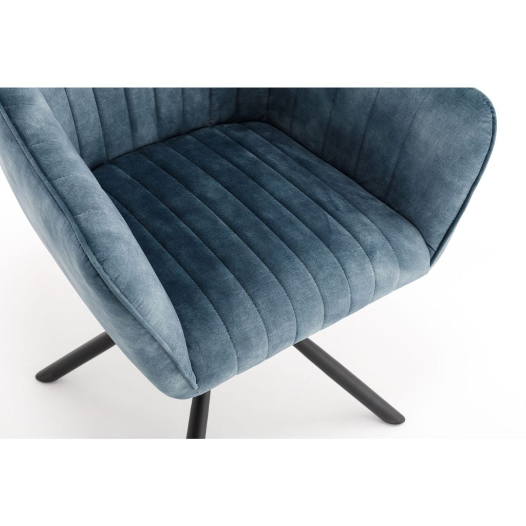 Blue velvet armchair with black metal legs on a white background