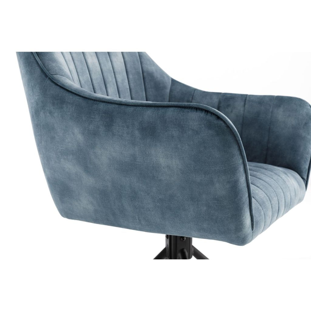 Blue velvet armchair on a white background