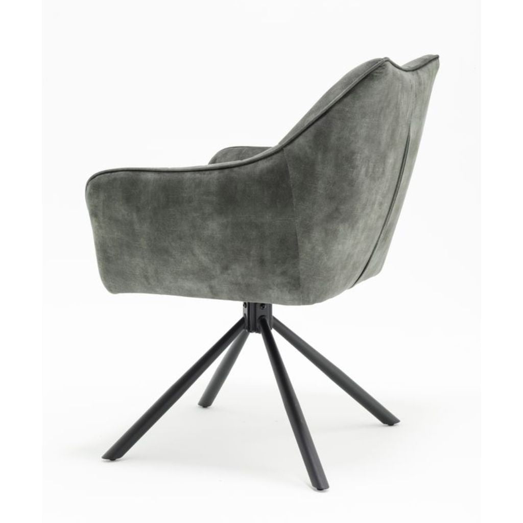 Green armchair with a black metal base on a white background