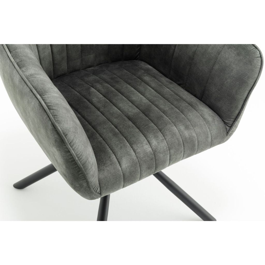 Green velvet chair with black metal legs on a white background