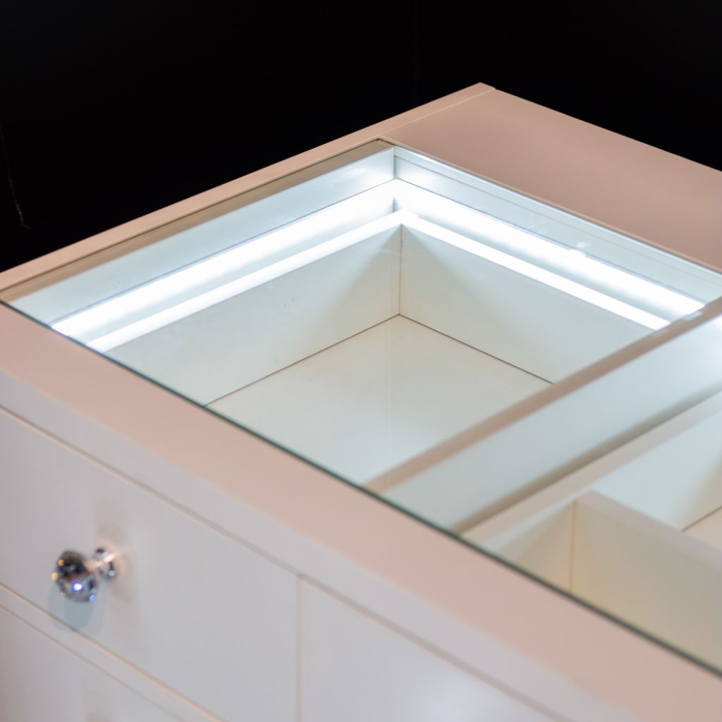 The glass top features LED interior lights to proudly display all your cosmetics.